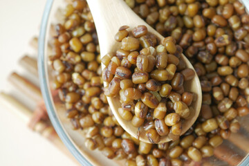 A Detailed CloseUp of Deliciously Cooked Mung Beans Resting in a Wooden Spoon for Presentation