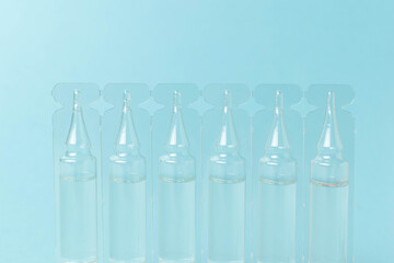 Transparent Medical Ampoules on Light Blue Background for Healthcare and Pharmaceutical Themes