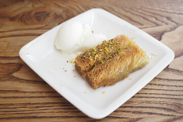 Savor the Delicious Baklava served with smooth Ice Cream on a beautiful White Plate