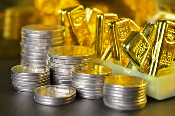 Stacking coins with the rows of gold bars . Gold is hard commodity goods, risk asset, tangible value that used to be gold reserve, save assets during war and economic crisis