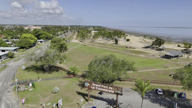 Drone flies north over the entire park Grand Parc de la Cocoteraie in Kourou, French Guiana, France