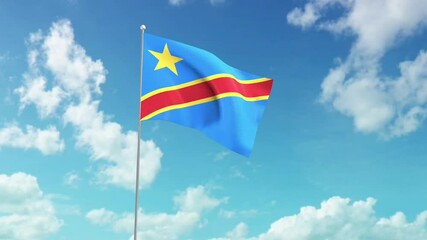 National flag of the democratic republic of the Congo, flying against the blue sky.