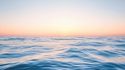 Obraz premium Serene ocean waves under a pastel sky during sunrise or sunset. Tranquil seascape