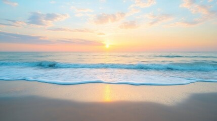 Obraz premium Serene beach at sunset with gentle waves and a colorful sky.