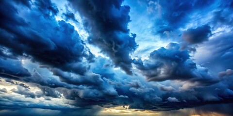 Obraz premium Gloomy blue storm clouds casting shadows under sunlight, stormy, overcast, dramatic, weather, atmosphere, cloudy, dark, ominous