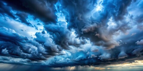 Obraz premium Gloomy blue storm clouds passing under sunlight, dramatic, weather, ominous, dark, overcast, sky, nature, eerie, atmosphere