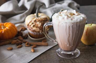 Hot chocolate with whipped cream and cinnamon on top paired with a spiced apple and almond muffin