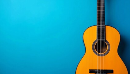 Obraz premium Acoustic guitar on a vibrant blue background, showcasing its craftsmanship and design.