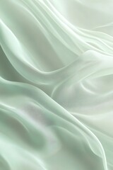 Fototapeta premium A soft, translucent fabric in a delicate mint hue, gently draped, showcasing intricate patterns that create a harmonious texture.