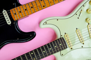 Electric guitar on a pink background, close-up, top view