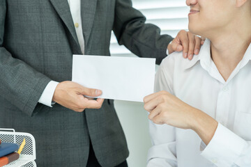 Businessmen receive salary or bonuses from management or Boss. Company give rewards to encourage work. Smiling businessman enjoying a reward at the desk in the office.