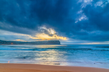 Cloud covered sunrise at the seaside