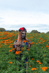 Catrina in a field of marigold, feminine and flowery portrait.