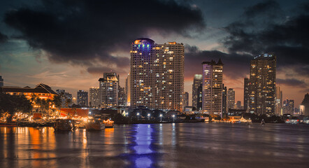 Bangkok skyline by night over the river