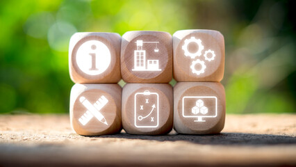 Wooden blocks displaying icons representing building information modeling, showcasing modern architecture and digital design tools.