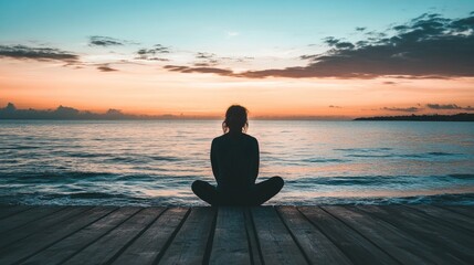 Person Meditating on Pier at Sunset