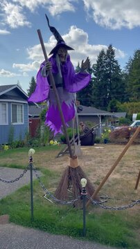 Outside Halloween decorations with witch on the broom, witch brew, guillotine, werewolf, wooden coffin. Everett, WA, USA - 5 October 2023