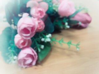 Blur image of bouquet of roses, Pink red and white rose with green leaves on wooden table