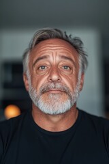 Obraz premium Portrait of a Mature Man with a Thoughtful Expression in a Modern Setting