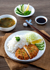 Tonkatsu Pork Rice cutlet and shredded cabbage on a white plate