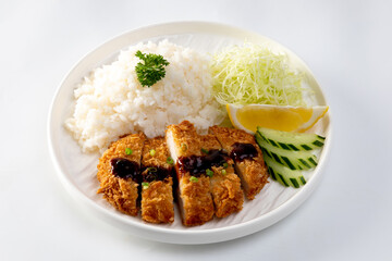 Tonkatsu Pork Rice cutlet and shredded cabbage on a white plate