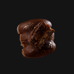 Macaron cookie isolated on a dark grey background.