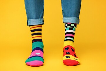 Quirky mismatched socks on feet, fun and playful, National Sock Day uniqueness.