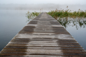 Fototapeta premium wooden jetty on a cold misty autumn morning