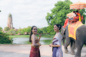 women in traditional clothing on Buddhist on background. Portrait women in traditional clothing , Thai traditional in Ayutthaya, Thailand.