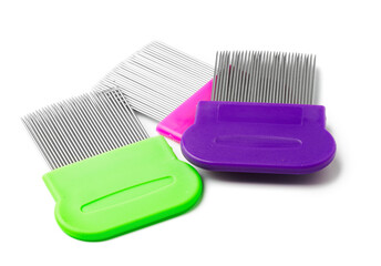 Colorful plastic and metal combs on a white background