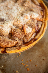 Close-up of freshly baked golden apple crumble dessert