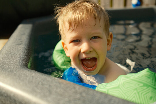 Excited boy screaming in swimming pool