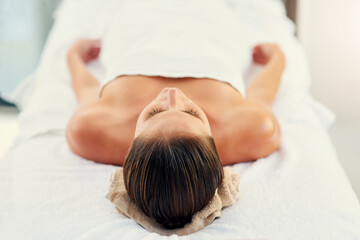 Beauty, bed and massage with woman in spa to relax as customer for hospitality or wellness. Healing, holistic and peace with person on table in luxury hotel or salon for detox, retreat or treatment