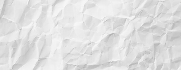 Obraz premium Crumpled white paper texture with wrinkles and creases, isolated on a white background, ideal for design, backgrounds, or texture use.