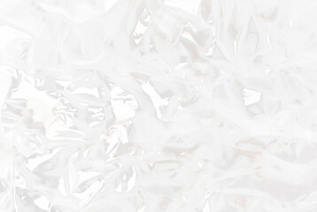 High-resolution close-up of crumpled transparent plastic sheet texture, ideal for use in packaging, backgrounds, or abstract design concepts.