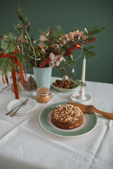 Delicious apple pie with almond petals on a festive Christmas table.