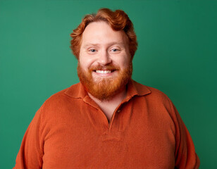 Obraz premium Studio Portrait of Handsome Mature Man Happily Smiling Against Green Background