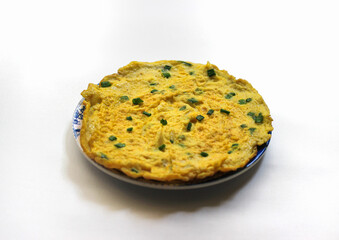 Simple egg omelette with herbs on white background