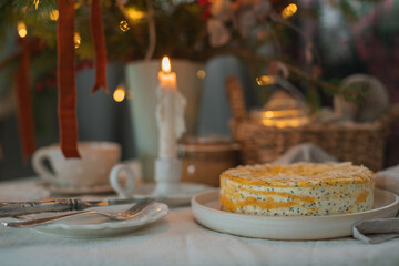 Healthy cottage cheese cake with poppy seeds and almond petals on the table with a candle and Christmas decorations.