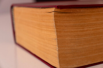  coloured damaged leather cover of a very old book. yellowed natural paper texture. isolated on white background. clean close-up.