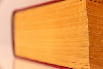  coloured damaged leather cover of a very old book. yellowed natural paper texture. isolated on white background. clean close-up.