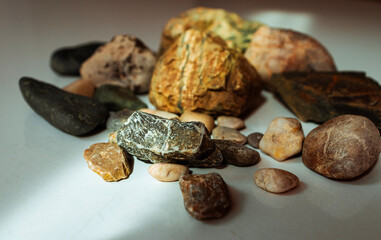 photo of pebbles of various colors sitting together on a white background