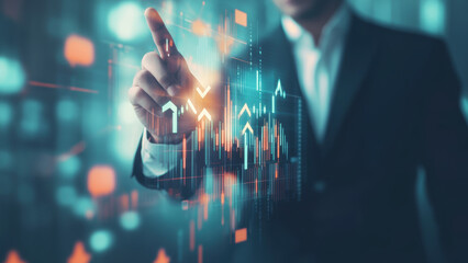 Obraz premium Man in a suit pointing at a graph on a screen.
