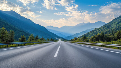 A long, straight road leading towards a mountain range at sunset.