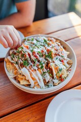 eating gourmet nachos at outdoor restaurant