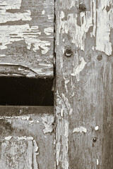 Detail of part of an old wooden workshop door, with paint peeling off (part of a photography series).