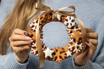 A ginger cookie Christmas wreath in the hands