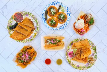 Mexican beef tacos with jalapenos, parsley, and fresh lime on ceramic surface
