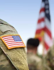 US soldiers. US army. USA patch flag on the US military uniform. Soldiers on the parade ground from the back. Veterans Day. Memorial Day. © Bumble Dee