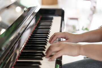 Fototapeta premium Girl learn to play piano.&nbsp;woman hand playing piano .